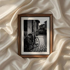 Classic European street photography featuring a vintage bicycle beside cobblestone streets in black and white, printable wall art for modern farmhouse and minimalist homes.
