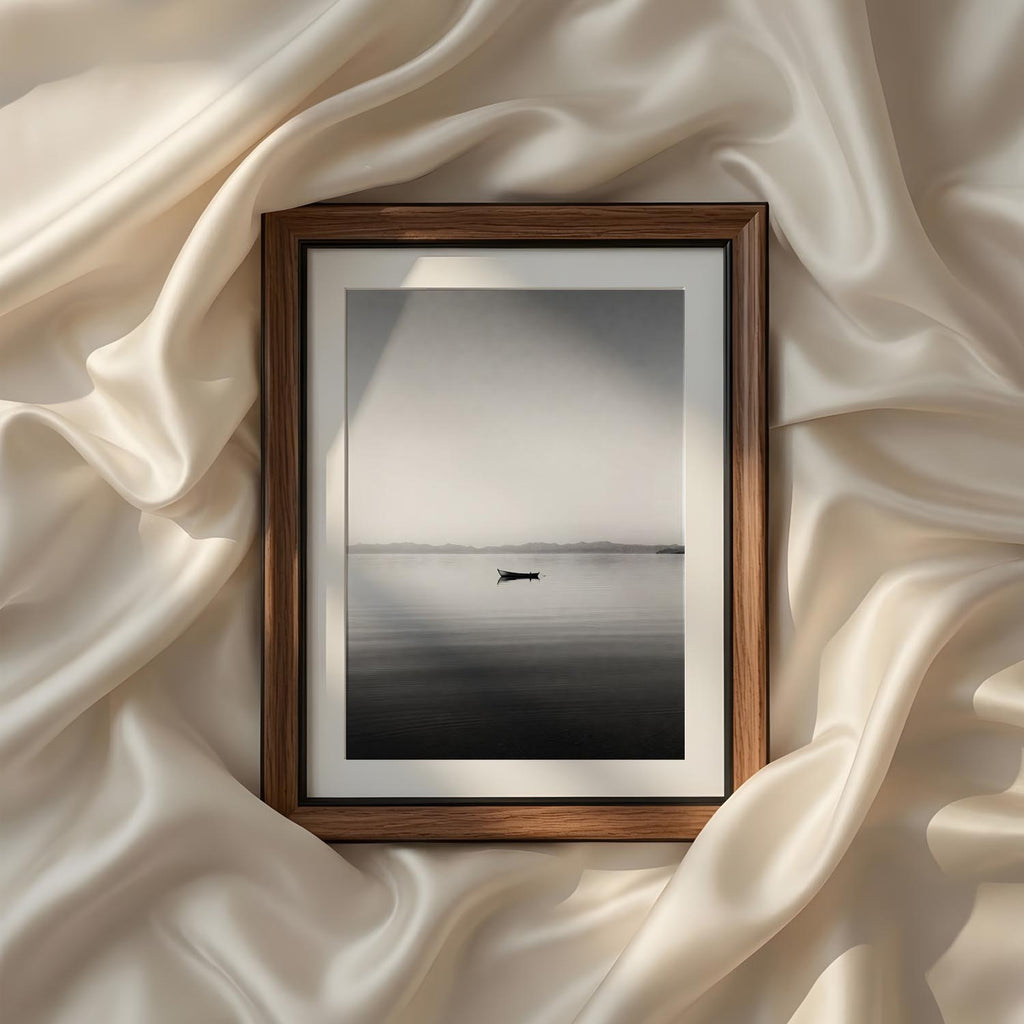 Minimalist black and white lake photography featuring a solitary boat on calm water, printable fine art wall decor for modern living rooms, bedrooms, and peaceful interiors.