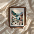 Charming Italian village square overlooking Lake Como with a stone fountain, outdoor café seating, pastel Mediterranean buildings, snow-capped mountains and crystal blue water. Vintage Italian Mediterranean coastal wall art printable, landscape canvas print, poster, digital artwork and elegant home decor.
