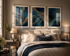 Blue Gold Modern Abstract Triptych Printable Wall Art Set of 3 above a sophisticated upholstered bed in a luxury modern bedroom with natural wood frames and crisp white mat board. Soft golden sunlight creates beautiful reflections across the artwork while layered neutral bedding, designer nightstands, ceramic lamps, linen curtains and elegant décor complete this Blue and Gold Abstract 3 Panel Gallery Wall Prints Bundle Instant Download bedroom inspiration.