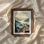 Panoramic view of an Italian lakeside town with terracotta rooftops, tranquil blue water, rolling mountains and soft pastel clouds creating timeless Mediterranean scenery. Coastal printable wall art, vintage landscape artwork, canvas print, poster and elegant gallery wall decor.