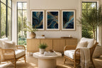Blue Gold Modern Abstract Triptych Printable Wall Art Set of 3 displayed in elegant 3:4 proportion wood frames with refined white matting above a minimalist oak sideboard inside a luxury sunroom. Blue and gold abstract gallery wall prints complement rattan seating, travertine coffee table, indoor olive tree, woven rug, and floor-to-ceiling windows overlooking landscaped gardens. Printable instant download home décor.