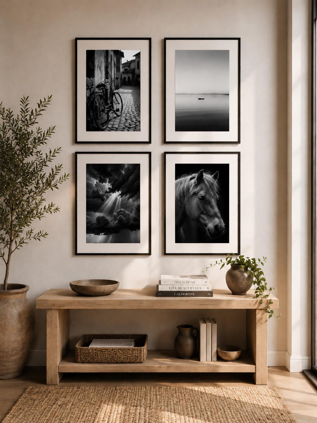Minimalist entryway gallery wall featuring four black and white printable fine art photography prints from the Timeless Monochrome Wall Art Collection styled with modern organic home decor.
