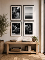 Minimalist entryway gallery wall featuring four black and white printable fine art photography prints from the Timeless Monochrome Wall Art Collection styled with modern organic home decor.