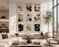 Abstract Beige Black White Neutral Printable Wall Art Kit Set of 9 elegantly displayed as a symmetrical 3x3 gallery wall in a bright American modern minimalist living room. Natural oak frames, crisp white mats, and floor-to-ceiling windows fill the space with soft white daylight, creating delicate reflections that enhance the authentic beige, ivory, black, and charcoal tones of each artwork. Positioned above a floating wood media console and surrounded by refined neutral furnishings, sculptural décor, and l